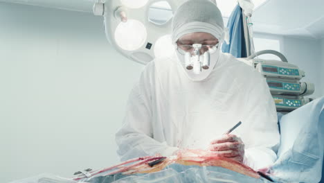 surgeon in binoculars operates patient. man doctor in uniform uses medical instruments during coronary artery bypass surgery in operating room