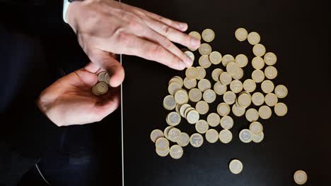 Slow motion coin sorting scene symbolizes financial instability, budget pressure
