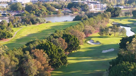 Drone footage captures a serene golf course in Gold Coast, Australia, with lush greenery and vibrant lighting