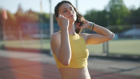 woman running on outdoor track in yellow sportswear