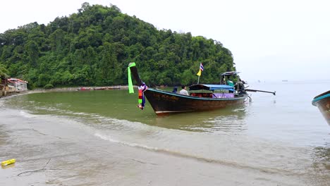 boat approaches shore in krabi, thailand
