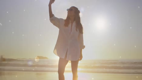 woman taking a picture in the beach