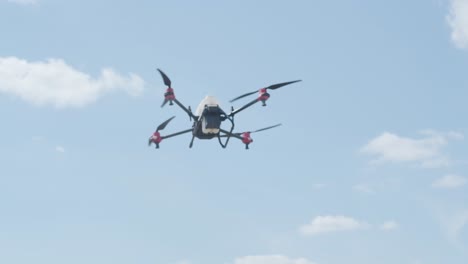 professional drone with camera flying in the blue sky