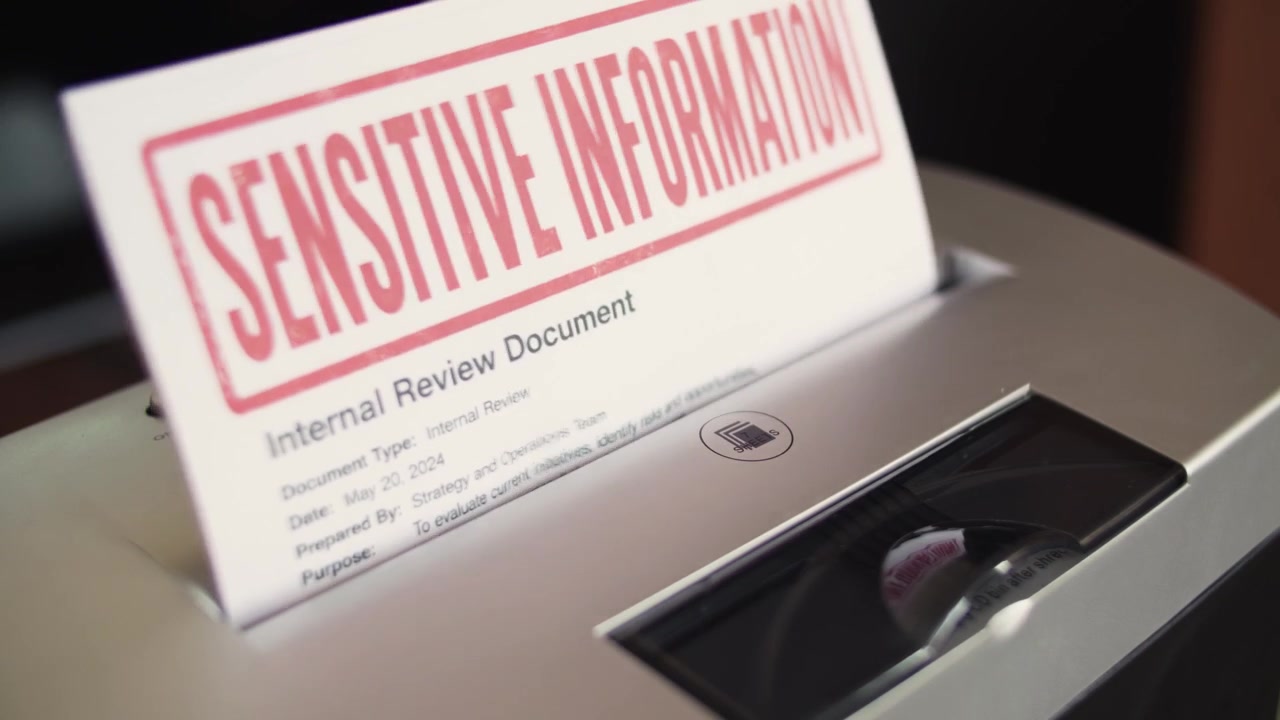 Sensitive information document slides into a shredder for secure disposal