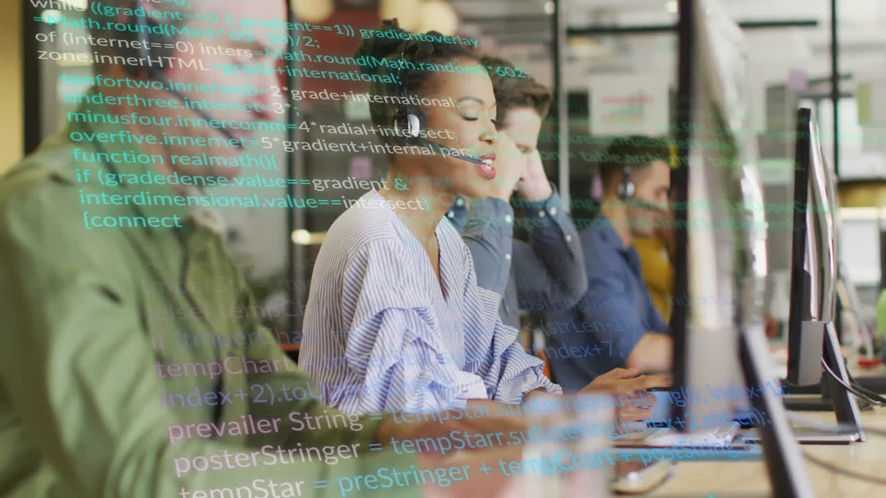 Programming code animation over diverse team working on computers in office