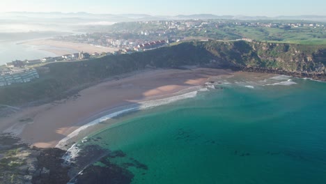 Overlooking-The-Suances-Town,-Spain.-Aerial,-Slow-Panorama