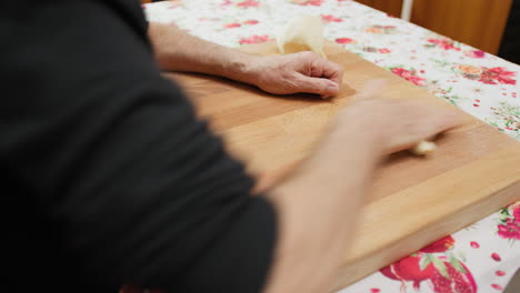 man's hands working raw dough in the kitchen in calabria