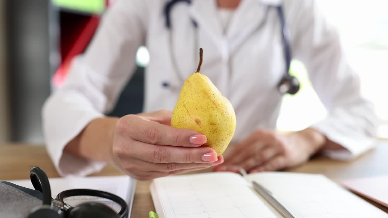 Doctor holding a pear