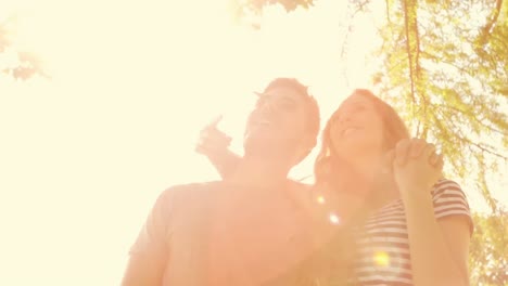 happy cute couple standing together in the park