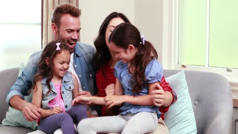 Happy-family-using-laptop-on-sofa-