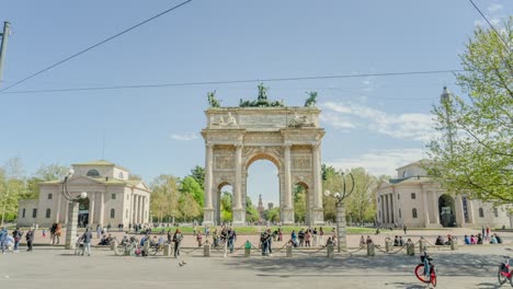 people visit arch of peace in historical center of milan