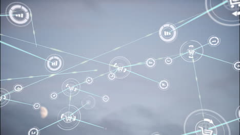 animación de la red de iconos digitales contra el cielo gris.