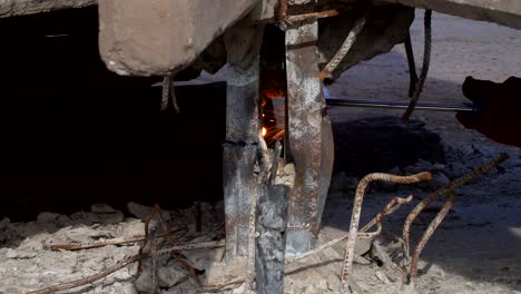 handheld, slow motion close view of sparks produced by a welder cutting a piece of steel-1