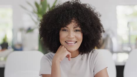 Happy-african-american-woman-sitting-at-table,-having-video-call,-slow-motion