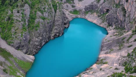 oval shaped lake with beautiful cyan colored water