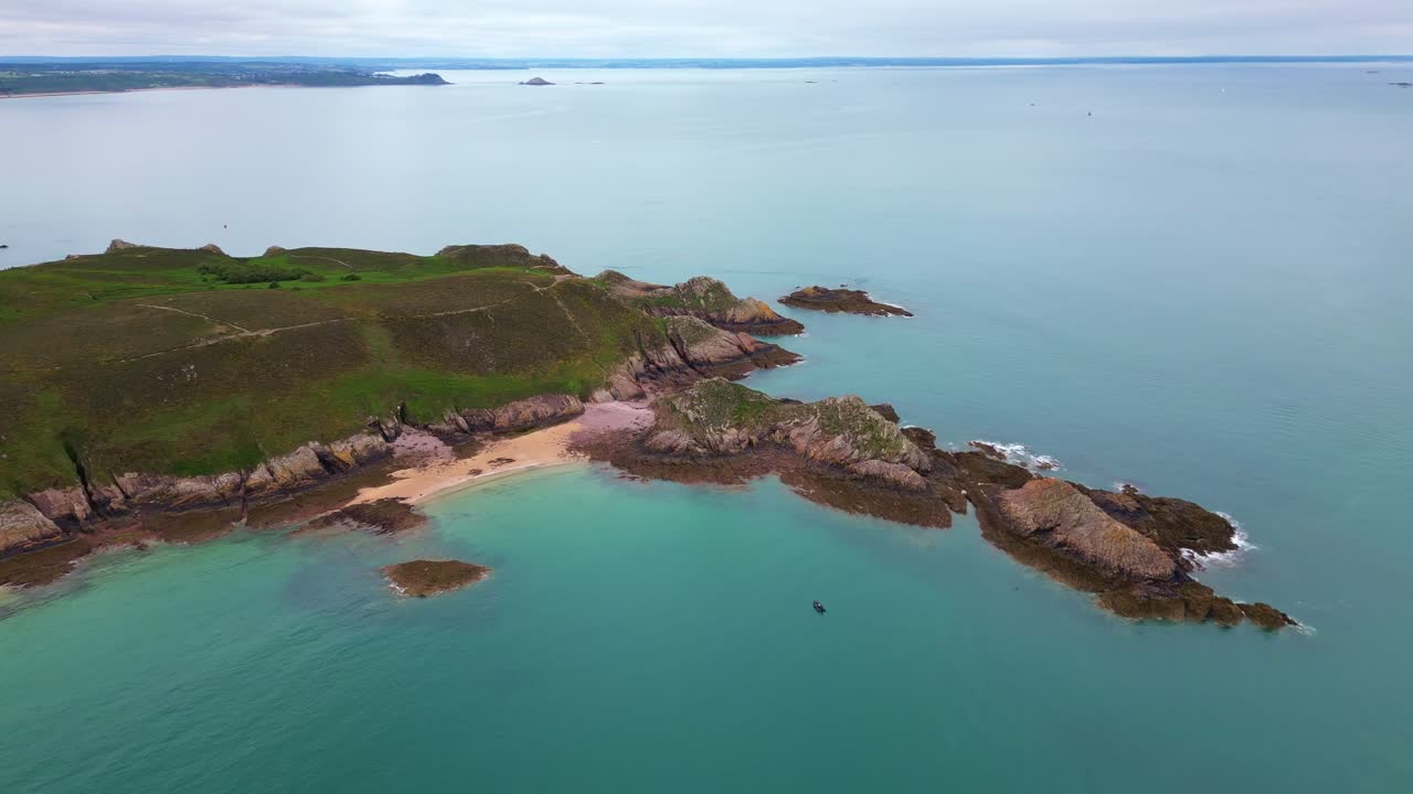 Panorama drone shot of the Cap d'Erquy rocky coastal bay with calm shallow waters, Côtes-d'Armor, Brittany, France.