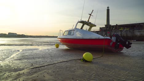 Boat-is-on-dried-coast-beach-close-to-harbour-in-sunset-beautiful