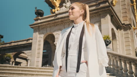 stylish young woman looking away in old park.