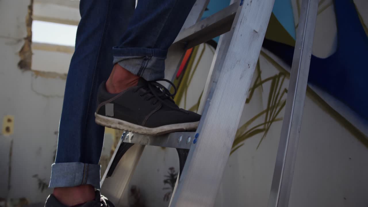 Graffiti artist painting with aerosol spray on the wall 4k