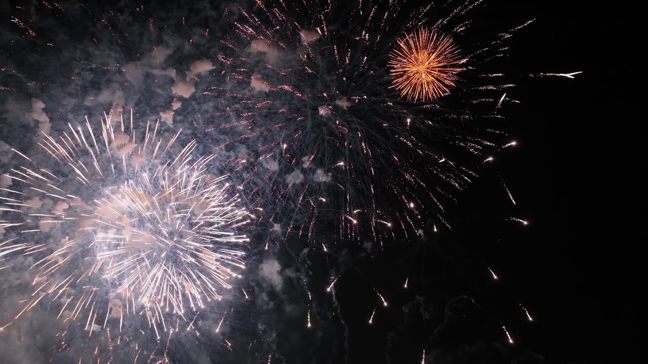Aerial view of colorful New Years fireworks flashing on a dark, night sky