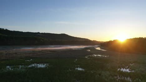 sunrise over a marsh and river