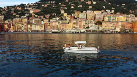 scenic view of a colorful coastal town in italy with a boat on the mediterranean sea