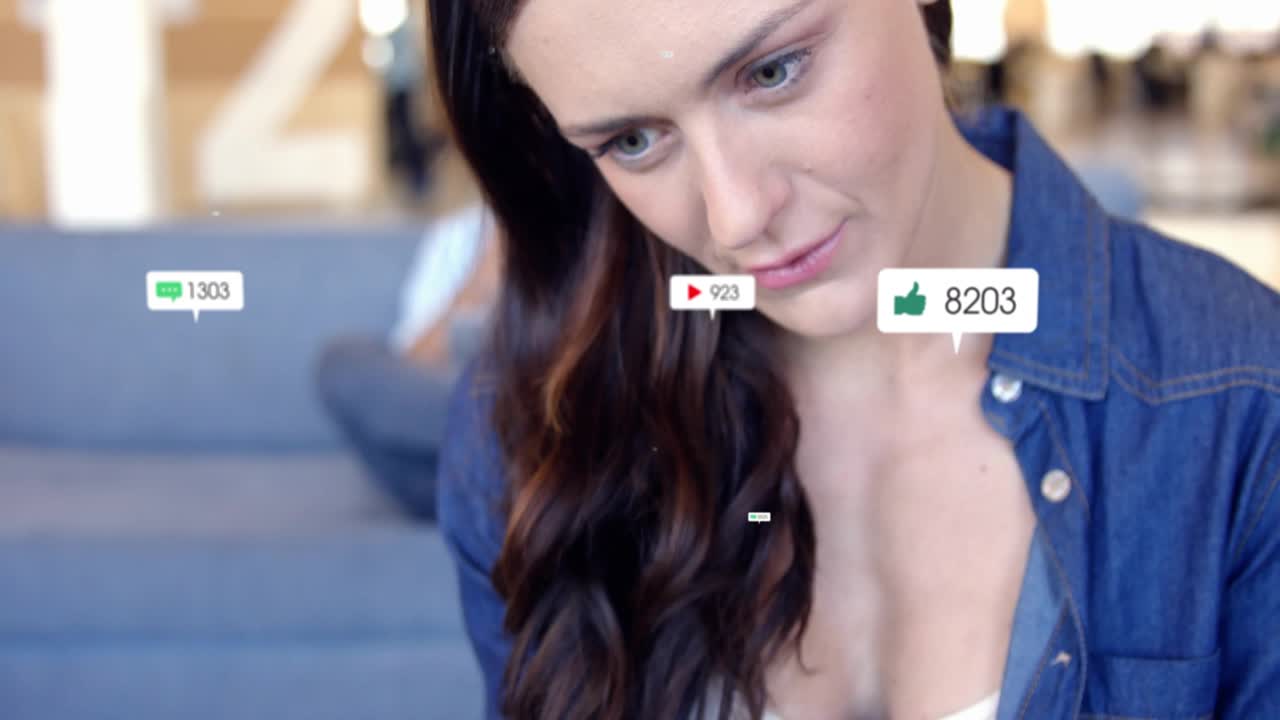 Woman holding tablet viewing incoming notifications floating and updating live, showing engagement