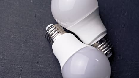 led light bulbs on table with dark background