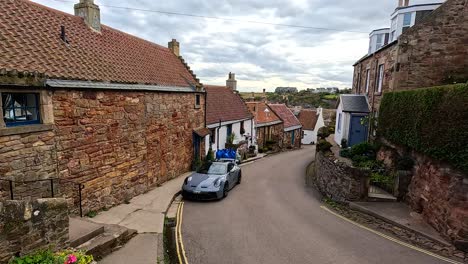 car navigating narrow street in historic village