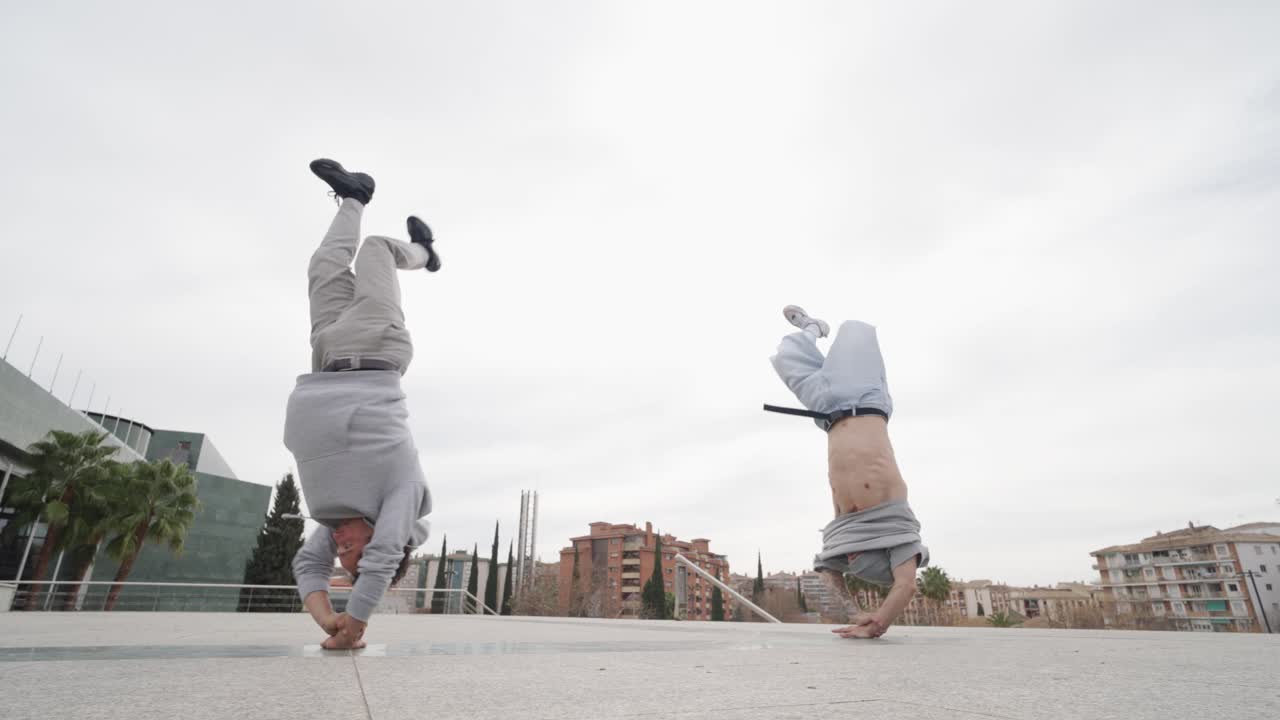 Breakdancing performers executing dynamic moves, displaying high-energy street dance skills
