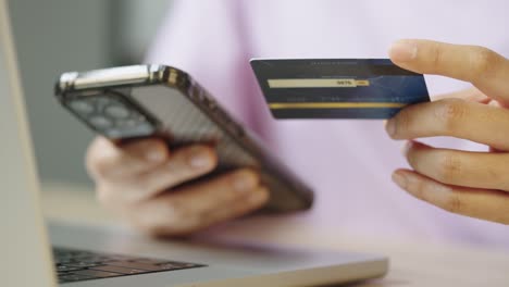 a woman is using credit card to pay for online shopping on an application mobile by smartphone.