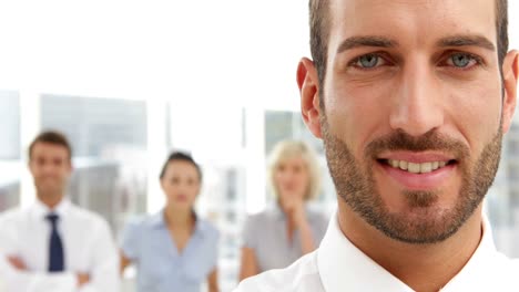 Businessman-standing-in-front-of-his-team