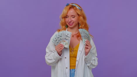 Proud-arrogant-rich-stylish-girl-holding-money-cash-in-dollars-banknotes,-smiling,-looking-at-camera