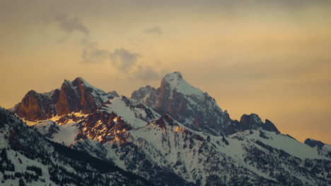 grand teton time-lapse during golden hour with snow capped mountains in national park wyoming united states