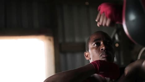 boxer punching a punching bag in the gym