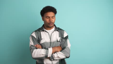 disagreeing young man shaking head in blue studio