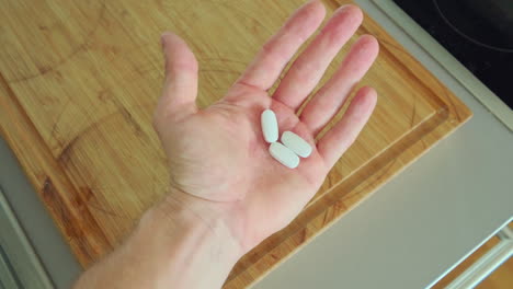 hand palm open with medicine tablets. close up