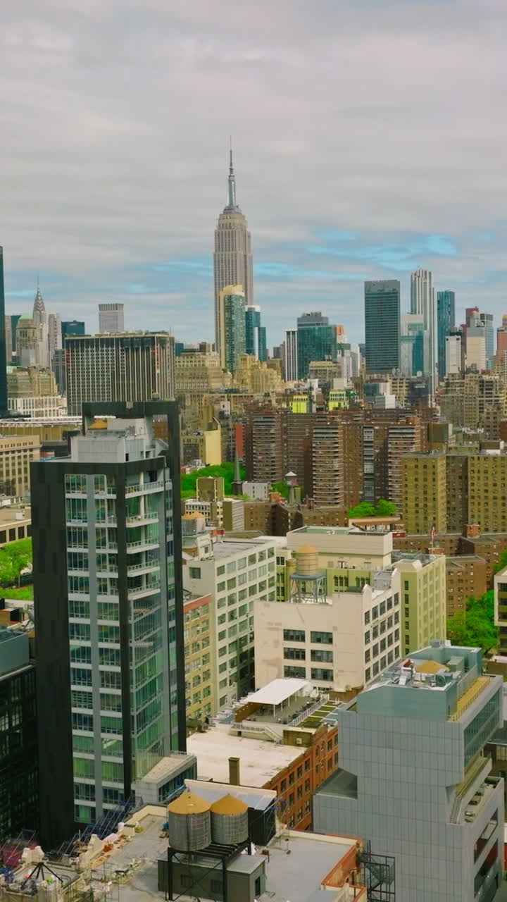 Rising over residential area of New York at daytime. Lively city on the cloudy day. Aerial footage. Vertical video
