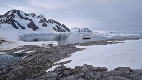 Tourists-visit-Antarctica-Booth-Island-with-ship-and-people