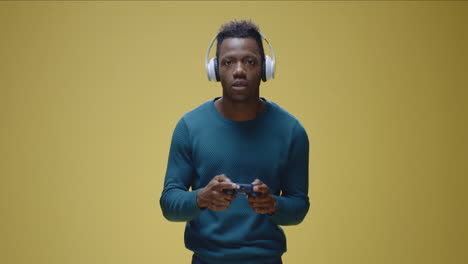 man playing video game with headphones on