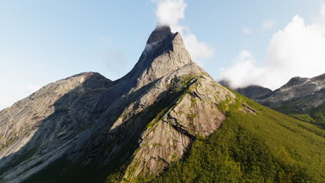 stetind mountain with its distinctive obelisk-shape against blue sky in northern norway