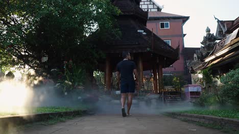 man walking through a thai temple