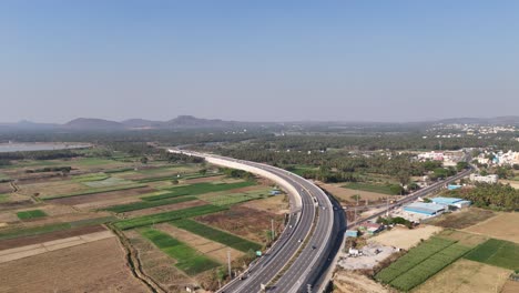 aerial view of a newly constructed or well-maintained elevated highway, gracefully curving through a diverse landscape. showcasing modern infrastructure designed to streamline traffic