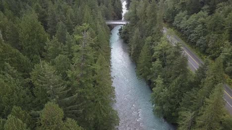 aerial: highway twenty bridge on nusatsum river in bella coola valley