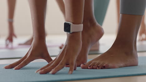 close up feet yoga class women stretching practicing half forward bend pose enjoying fitness studio training workout