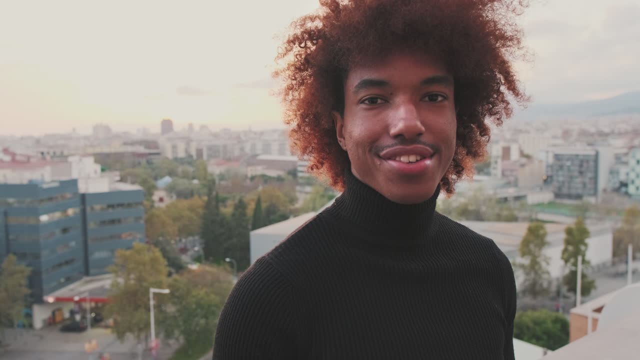 Portrait of a man with afro hair in a city