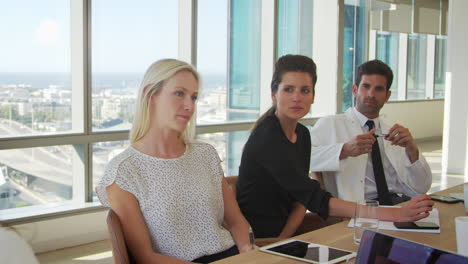 group of medical staff meeting around table in hospital