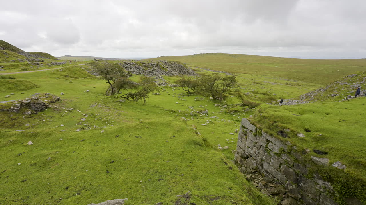 View of a landscape with hills, ruins and stone walls