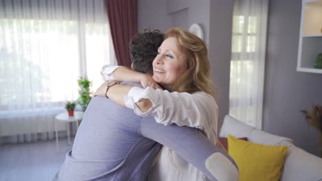 happy mother hugging her son at home and they are happy.