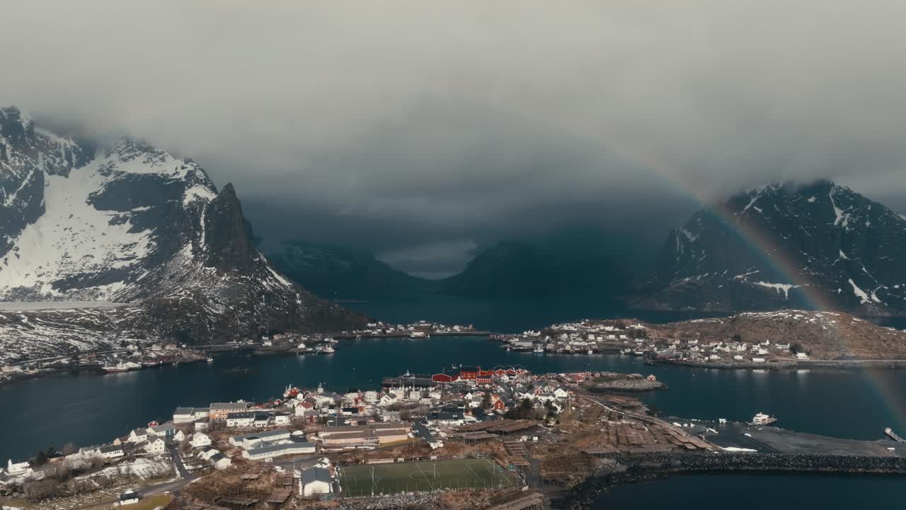 Beautiful Rainbow Over Reine Fishing Village In Nordland, Norway. - aerial shot